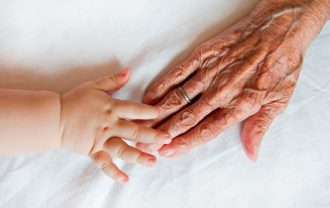 old-young hands touching