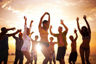 Diverse Young Happy People Dancing at Sunset