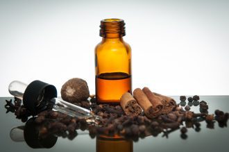 Various spices with essential oil bottle and dropper